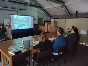 Cheshire Archives staff review film clips on a big screen